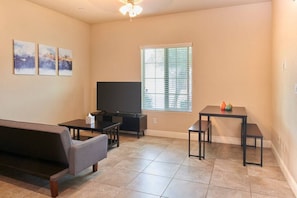 Open space- Living Room with 55" TV, Roku, dining table and chair.