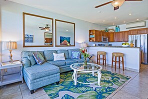 Unwind in this beautifully designed living room, featuring tropical-inspired decor, panoramic ocean views, and a seamless connection to the lush outdoor space.