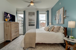 Bright and spacious bedroom with Queen bed and designer furnishings.