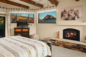 Main Suite w/ King Bed, TV, and Fireplace. For added flexibility, a child's playpen and memory foam twin platform bed are available in the walk-in closet.