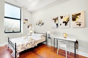 Smartly designed common space with a comfy couch, smart TV, and nice natural light.  All you have to do is log into your favorite streaming services and make it a TV night.