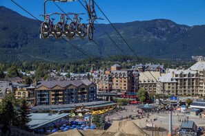 Panoramic views of alpine charm and bustling outdoor spaces create a serene retreat.