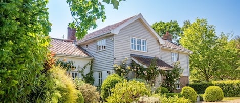 Foxhole Cottage exterior is draped in roses