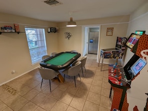 Game room with real poker table and arcade