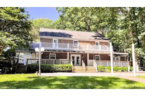 The large covered porch w seating overlooks the large yard, gazebo & Reservoir. 