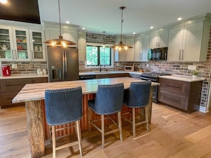Chef’s kitchen with barstool seating (open floor plan with dining & living areas)