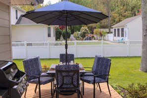The gas grill awaits your BBQ innovation next to the 6 seater patio table with extra large umbrella.