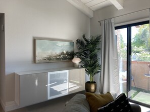 floating cabinet holds Blu-ray player and DVDs
