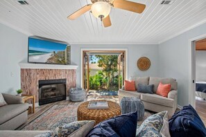 Coastal living room: French doors, smart TV, pull-out sofa. Cozy, sleeps 2.