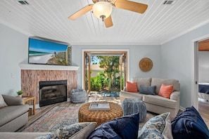 Coastal living room: French doors, smart TV, pull-out sofa. Cozy, sleeps 2.