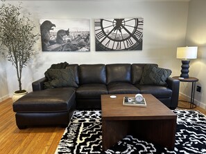 Large queen-sized leather sleeper sectional in living room 