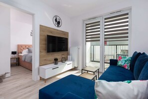 A modern TV unit with a wooden finish in a bright living area.
