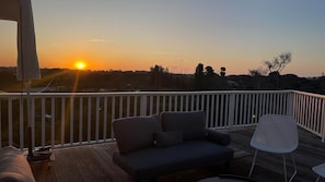 Large sundrenched deck offers a spectacular 270 degree view over the treetops towards the back beach dunes.