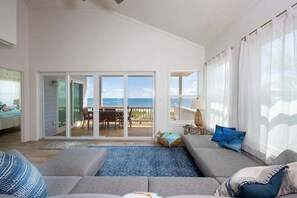 From the great room, step out through the eight-foot sliders onto the deck with its sweeping beach and ocean views.