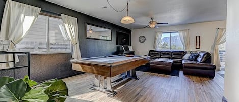 Dual delights await in the living room with a pool table – where
