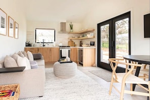 Open concept living, dining and kitchen with Scandinavian-modern touches
