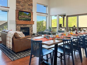 Vaulted ceilings and large windows flood the space with natural light, creating a warm and airy atmosphere.