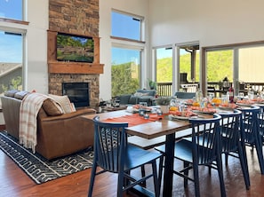 Vaulted ceilings and large windows flood the space with natural light, creating a warm and airy atmosphere.