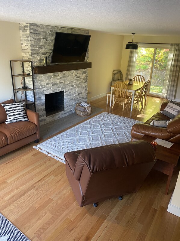 Living room and dining area with view out back door