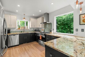 Modern kitchen with gas stove and granite countertops