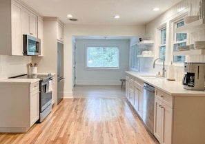 Upstairs kitchen with custom cabinets, Quartz counters, and walk-in pantry. 