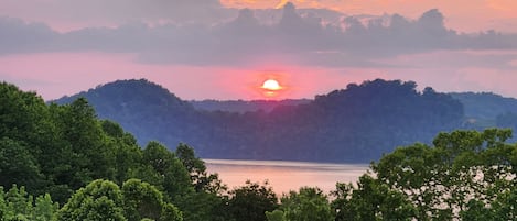 Enjoy the lake view and gorgeous sunsets from the top-level deck off the den.