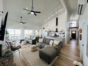 Great Room (living/dining/kitchen) and Caribbean views; hallway to bedrooms