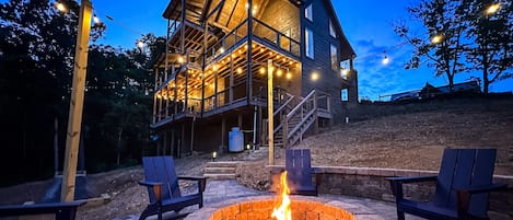 Parks Lodge has a large fire pit that's surrounded by string lights and Adirondack chairs. 