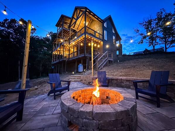 Parks Lodge has a large fire pit that's surrounded by string lights and Adirondack chairs. 
