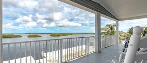 Relish the breathtaking water views and stunning sunsets from the expansive back porch.