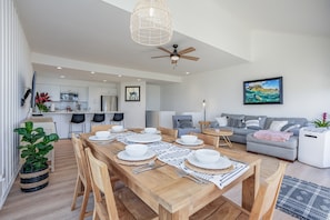 Open and airy living, dining, kitchen area with tall ceilings
