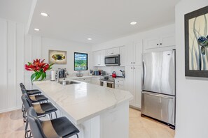 Make a gourmet meal in the remodeled well-stocked kitchen with ocean views