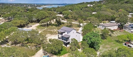 Aerial view of the rear of the house.  This home has direct lake access via private road down to the lake.