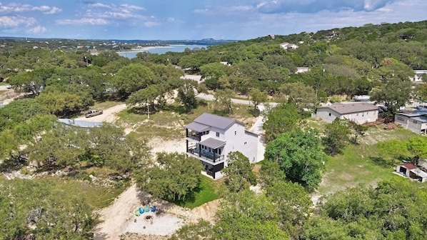 Aerial view of the rear of the house.  This home has direct lake access via private road down to the lake.