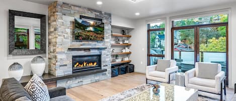 Living area with town/mountain views and walk out balcony, seating, firepit