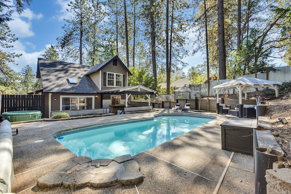 Enjoy a day by the pool overlooking the pine trees