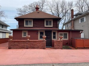 Your own parking area in front of your log cabin. Additional city parking lot is just across the street next to the red brick wall just north of the brick mini-mansion.