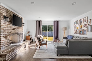 Spacious family room with a pull-out sofa and a smart TV