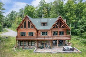 Lower level walk out patio with large hot tub and solo stove fireplace.