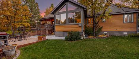 View of the backyard and the home's large windows for lots of natural light