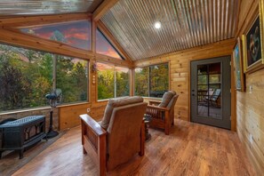 Arizona room with fireplace and recliners, perfect for a rainy day