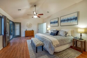 Primary bedroom with king-size bed, en-suite bathroom with jetted tub, walk-in closet, and access to the Arizona room. (Note: the room has a non-working gas fireplace.)