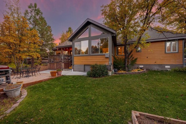 View of backyard and back side of house's large windows