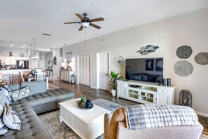 Comfortable Living Room with Recliner Chair, Sectional Sofa, and Large Flat Screen Smart TV