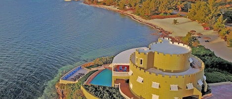 Aerial view at sunrise. The beach on the right is villa's private beachfront at the end of the driveway.