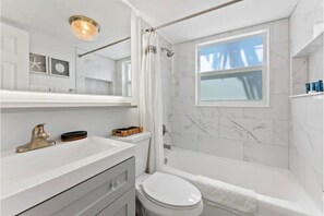 Fully renovated bathroom with shower/top and hot water. 