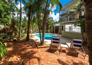 Tropical planting provides shade and privacy in the rear yard