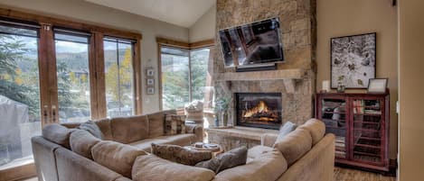 Cozy up by the fire on the plush couch while gazing at the mountain views