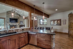 Granite countertops and seating for three at the island bar