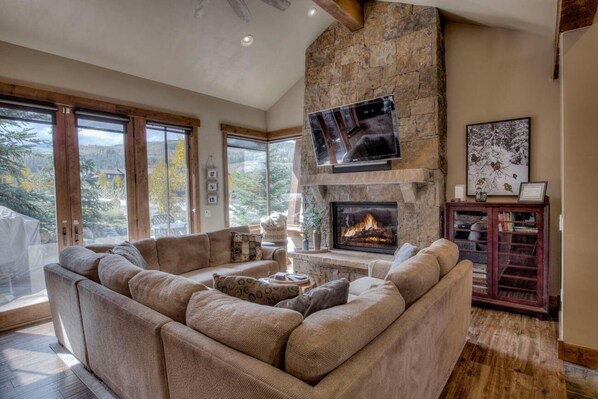 Cozy up by the fire on the plush couch while gazing at the mountain views